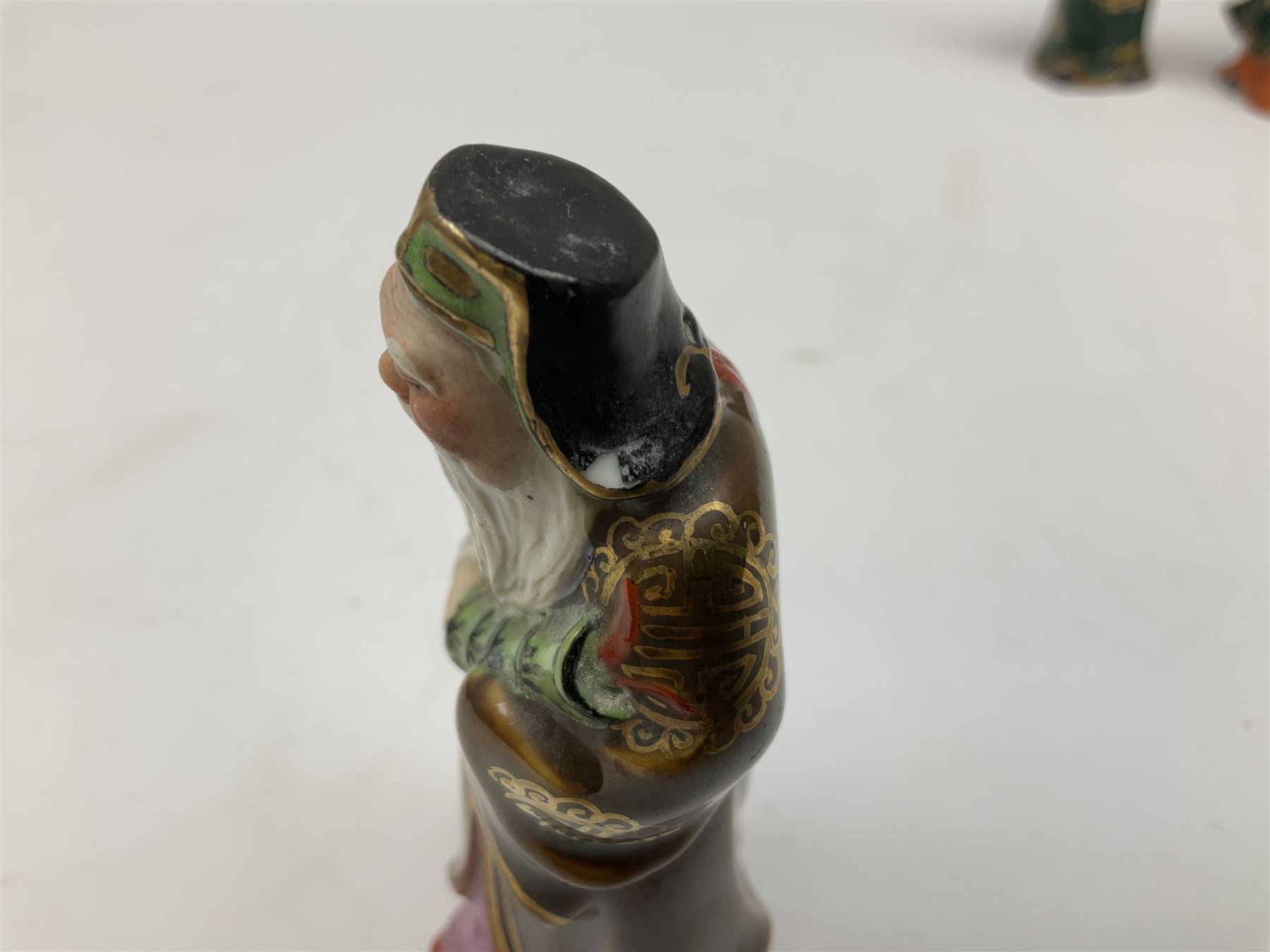 Japanese parquetry puzzle box L12cm; another Japanese puzzle box with marquetry top of Mount Fuji; eleven graduated Chinese figures including immortals; and Chinese figure of a lady standing on a hardwood base next to a horn table (14)