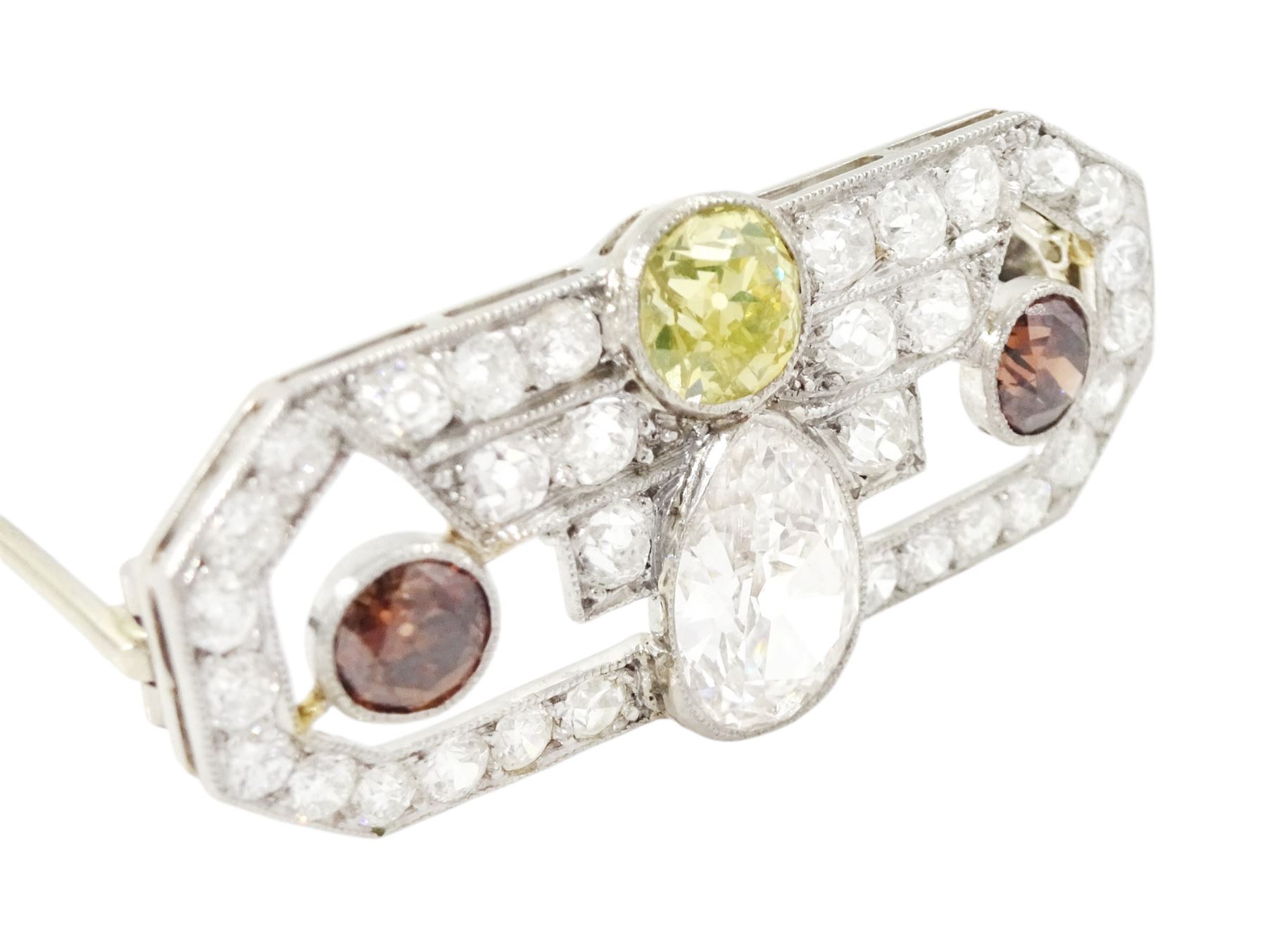 Early 20th century platinum diamond brooch, milgrain set with a pear cut faint brown diamond of approx 1.50 carat, an old cut fancy yellow / green diamond of approx 0.70 carat, and two old cut fancy orange / brown diamonds of approx 0.40 carat and 0.35 carat, surrounded by old cut white diamonds in an openwork setting, total white diamond weight approx 1.45 carat