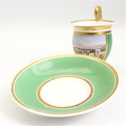 19th century French Empire design porcelain cup and saucer, the cup hand painted with a panel, titled beneath 'Library, St Leonards, Near Hastings', against a green and gilt ground, cup H10.5cm 