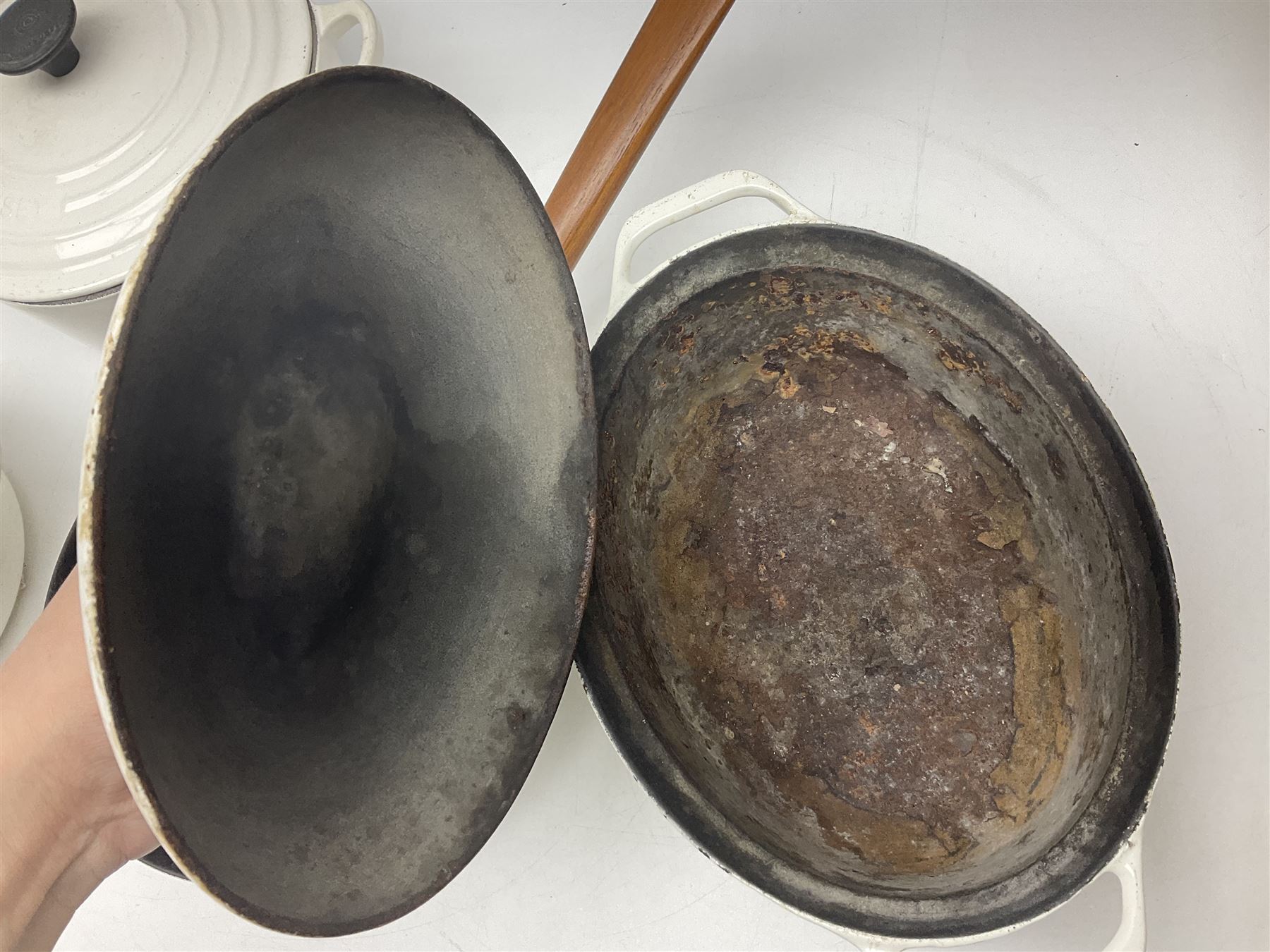 Le Creuset cast iron casserole dish, together with two Waterford cast iron dishes and a frying pan