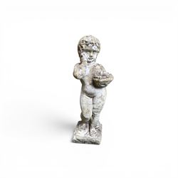Early composition stone figure of a boy with grape basket, original flakey white paint