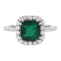 18ct white gold radiant cut emerald and round brilliant cut diamond cluster ring, with diamond set shoulders, stamped, emerald approx 1.80 carat, total diamond weight approx 0.50 carat