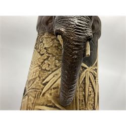 Pair of Bretby vases of tapering cylindrical form decorated with elephants, cranes and fishermen, the bodies with twin elephant mask handles, with coppered borders, raised upon three bun feet, stamped Bretby 2246 marks beneath, H32cm