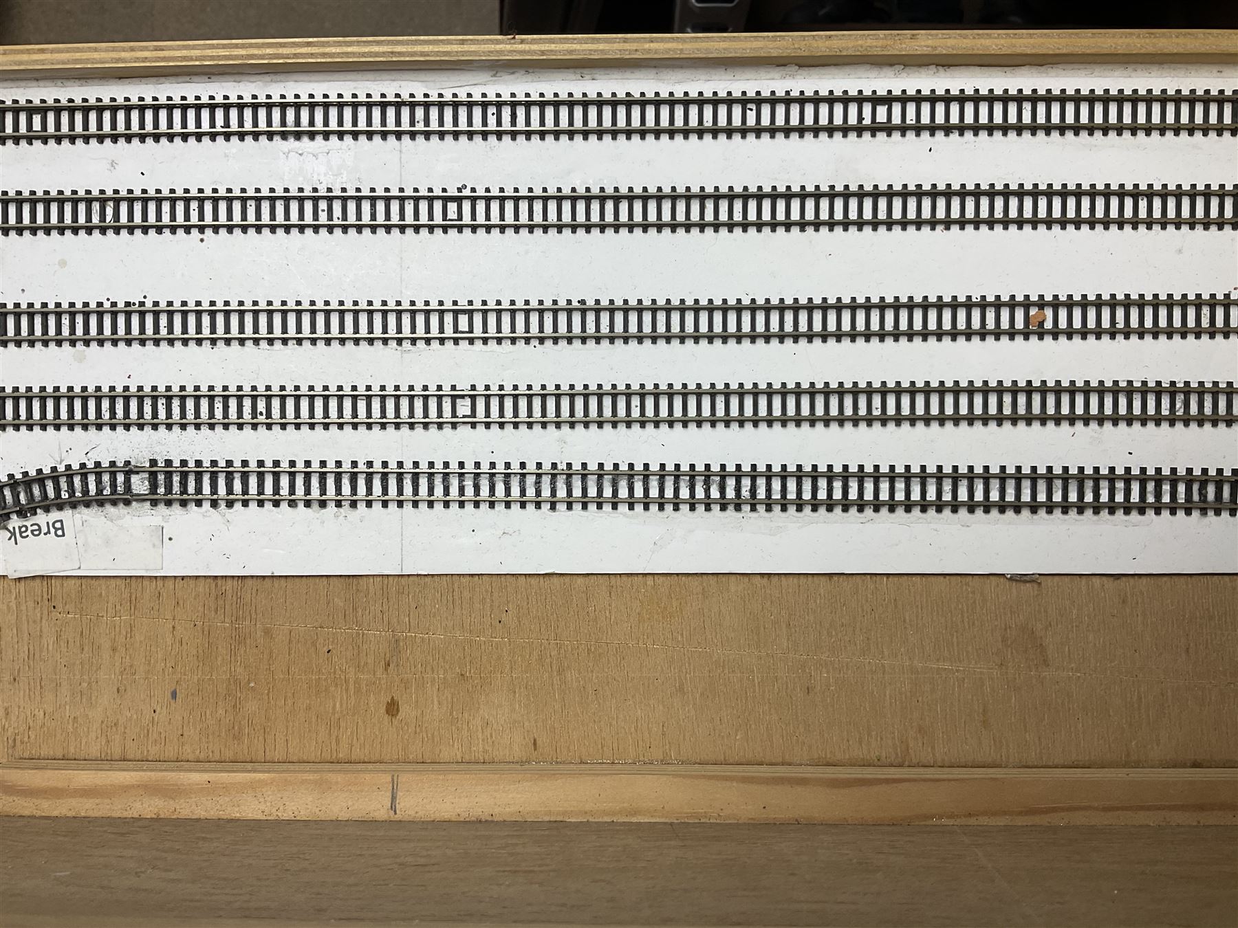 'Z' gauge continental scenic layout with folding legs, various loops of track and sidings with overhead cables, buildings including water tower, tunnels, roads with motor vehicles and figures, trees, haven with boats, backdrop diving wall hiding control units 150 x 50cm