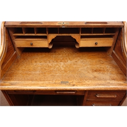  Early 20th century oak single pedestal tambour roll top desk, enclosing fitted interior, one long and three short drawers, W108cm, H118cm, D70cm  