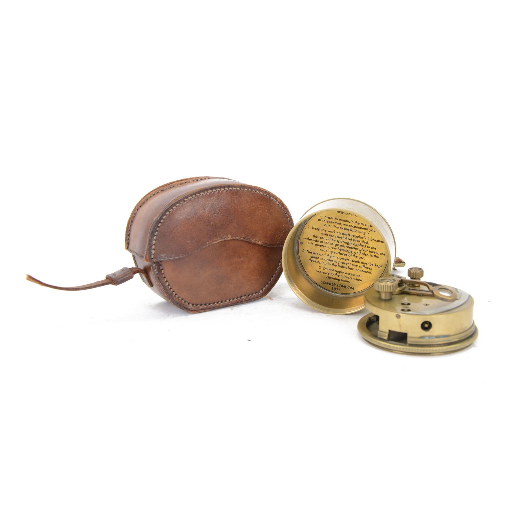 Brass pocket sextant, of circular form, the screw lid engraved 'Stanley London 1911', impressed to inner cover 'Important' with care instructions, contained within leather case