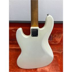 1963 Fender Jazz three-knob bass guitar; impressed with date code 7AUG63A on end of neck and serial no.L08587 on back plate; all original but re-finished in white in the 1970s; sold with photographs of the instrument in the 1960s with original finish and in the 1970s re-finished; L117.5cm; in original hard carrying case; Provenance: the professional guitar of Howard Livett from new to his death in 2005. Howard played in The Humperdincks, the backing group for Englebert Humperdinck, also played in the backing group for Max Bygraves and in the band Hedgehoppers Anonymous. The guitar is also sold with a manuscript letter of provenance from Howard's wife.