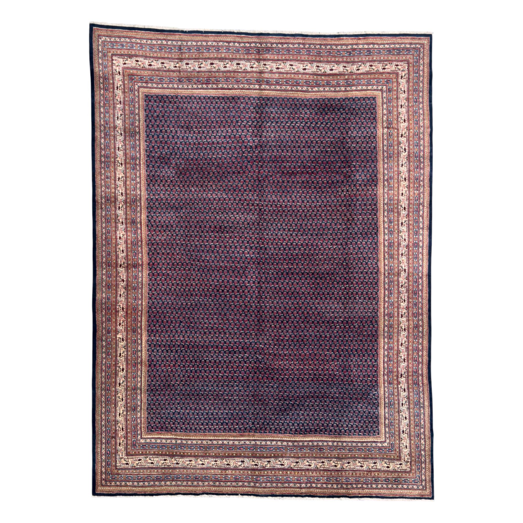 Northwestern Persian Bottehmir hand-knotted carpet, dark indigo field with an all-over design of boteh motifs arranged in diagonal rows, framed by multiple borders, main ivory border with stylized floral sprays between narrow geometric guard stripes, 362cm x 268cm