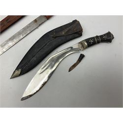 Indian kukri with 29cm curving steel blade and nickel mounted horn grip; in leather covered scabbard with one skinning knife L42cm overall; Hitler Youth knife with scabbard in relic condition; and three African graduated knives each with crudely carved wooden grips and painted leather covered scabbards (5)