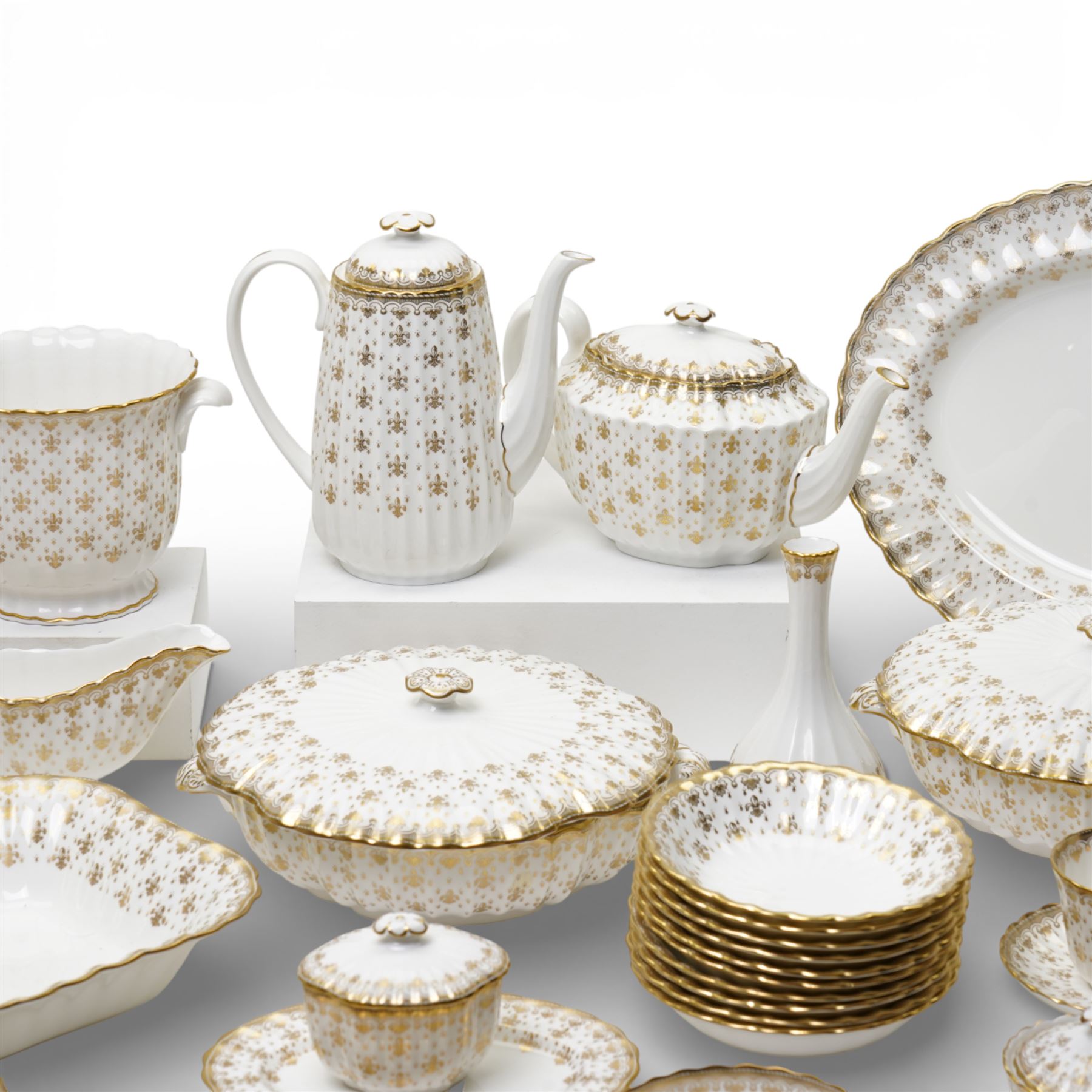Spode Fleur de Lys tea and dinner service for ten, comprising dinner plates, side plates of graduating sizes, bowls, twin handled soup bowls, three covered dishes, sauce boat and saucer, two serving dishes, open serving dish, teapot, coffee pot, milk jug, covered sucrier, cake plate, vase, jardiniere, cups and saucers