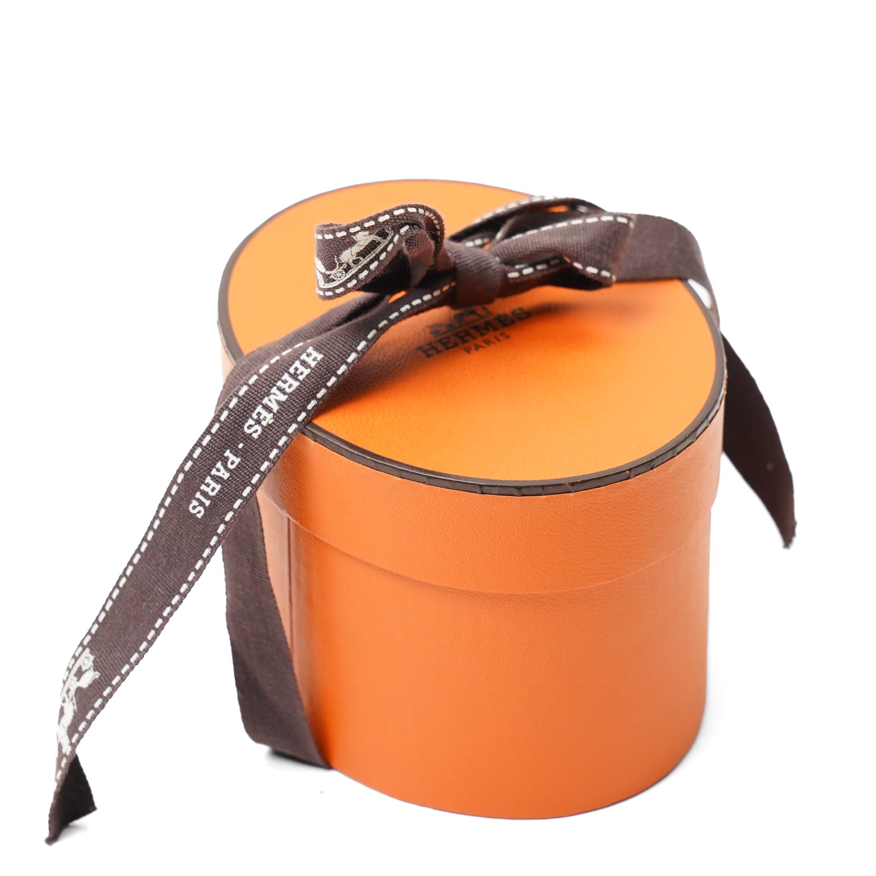 Hermès - two ‘Bolduc’ silk Twilly scarves, in orange/black and navy/brown colourways, together with three palladium-tone Médor pyramid Twilly scarf rings, with original dust bag and cylindrical box