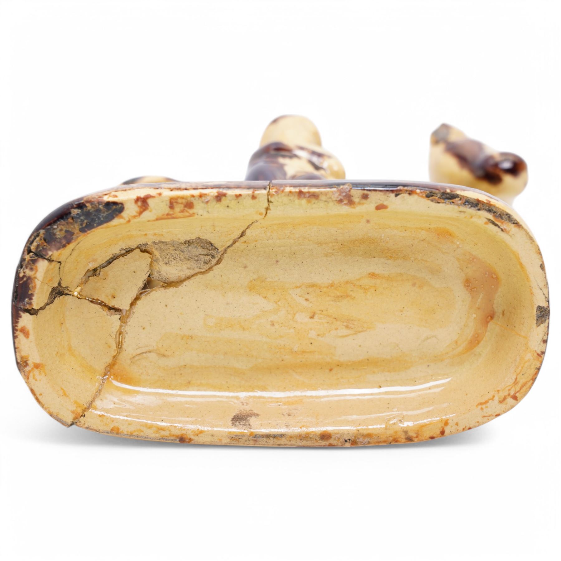 Early 19th century pottery model of a cow with drab colouring accompanied by a standing figure and a dog on naturalistic base, possibly South Yorkshire L14cm x H14cm