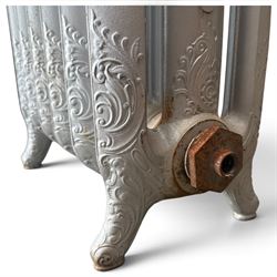 French ornate cast iron column radiator of Rococo Revival design, each section cast with scrolling foliate decoration with rocaille and cartouche motifs, with brass valve and integral bracket feet, in painted silvered finish