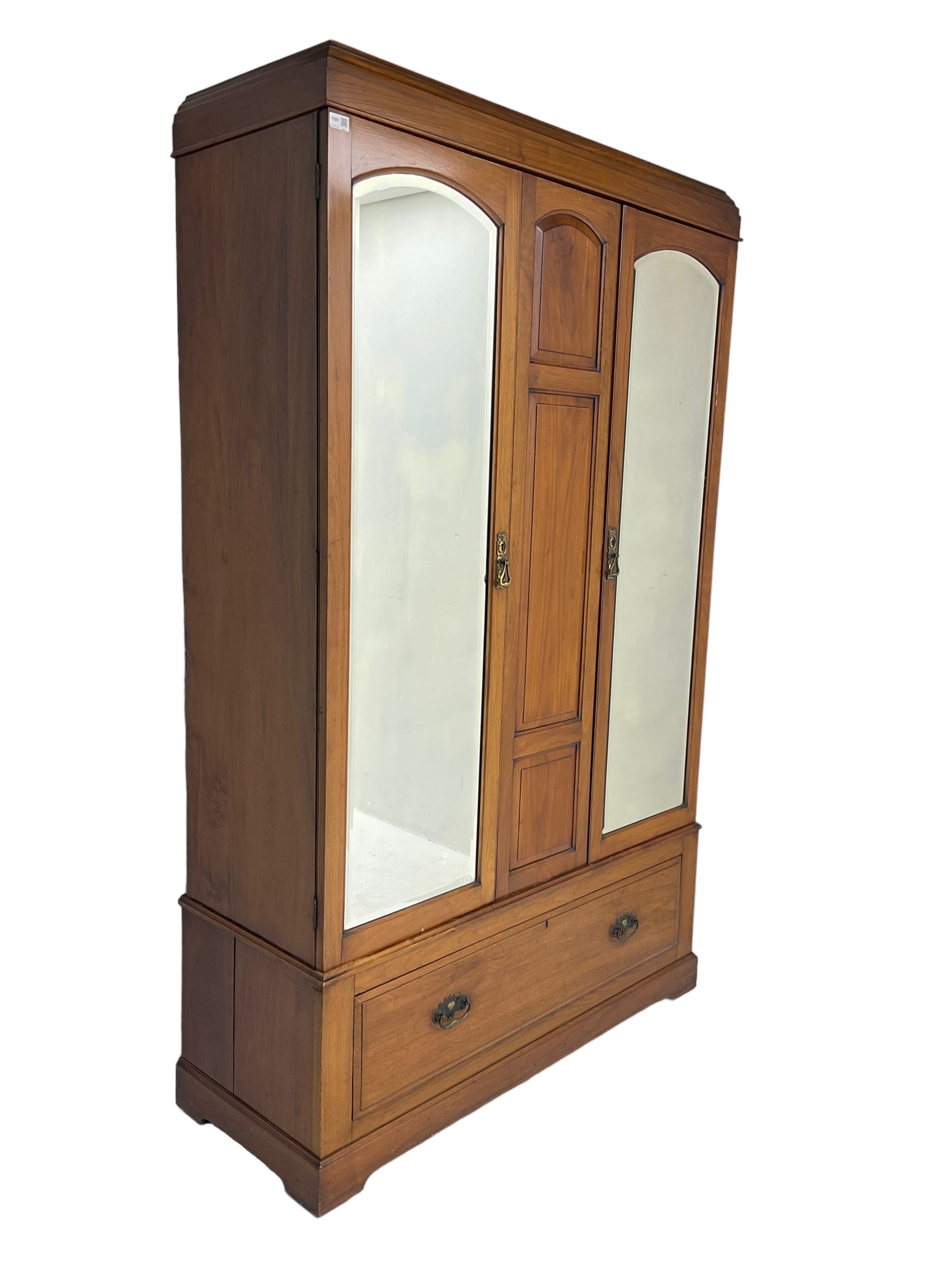 Edwardian walnut double wardrobe, fitted with two bevelled mirror panelled doors, single drawer to base