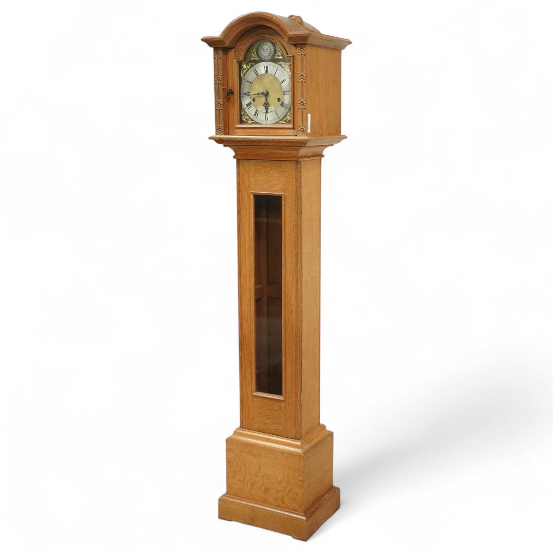 Mouseman - Oak 8-day grandmother clock, with a high quality weight driven movement and dial by Sinclair and Harding & Co of Cheltenham (No 477), brass break-arch dial with pierced steel hands, cast spandrels and a matted dial centre, silvered chapter with Roman numerals and minute track, dial pinned to  a two train rack striking movement, striking the hours on a cast bell, case with a full length glazed door and visible brass cased weights and conforming brass cased cylindrical pendulum. Signature carved mouse to the top of the arch of the case, from the workshop of Robert Thompson of Kilburn
With key.
Longcase.