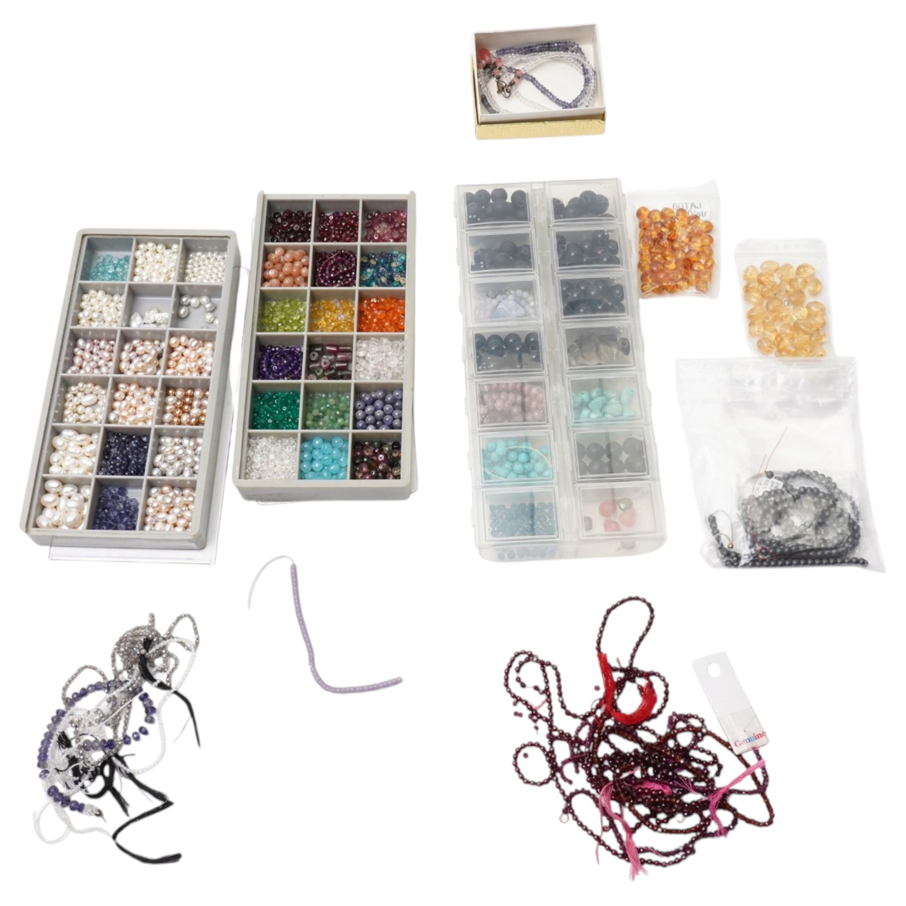 Collection of various beads, including turquoise, citrine, amethyst, garnet, iolite, ruby, onyx, hematite, rose quartz, smokey quartz, white quartz, lapis, amber, peridot, tourmaline, etc