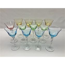 Ten coloured Adriana wine glasses by Abigails, to include blue, green, pink and yellow examples, each with part faceted bowl and twist stems, together with two similar orange examples with pulled stems, H24cm