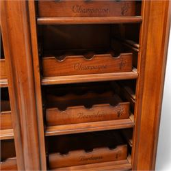 Cherrywood wine rack cabinet, moulded rectangular top over two glazed doors, fitted with eight slides each with three bottle holders inscribed with various wine types, single long drawer to the base 