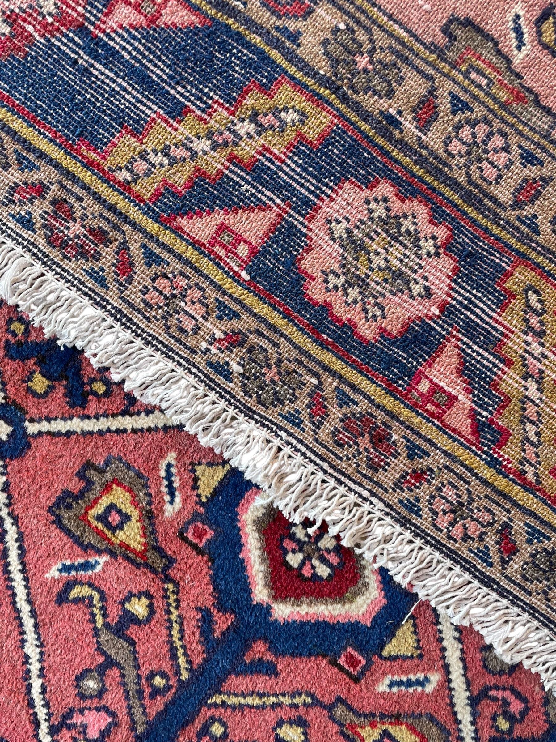 Persian Ardakan crimson ground rug, the field divided by lattice and decorated with stylised tree of life motifs, the border decorated with geometric flower heads, within guard stripes 