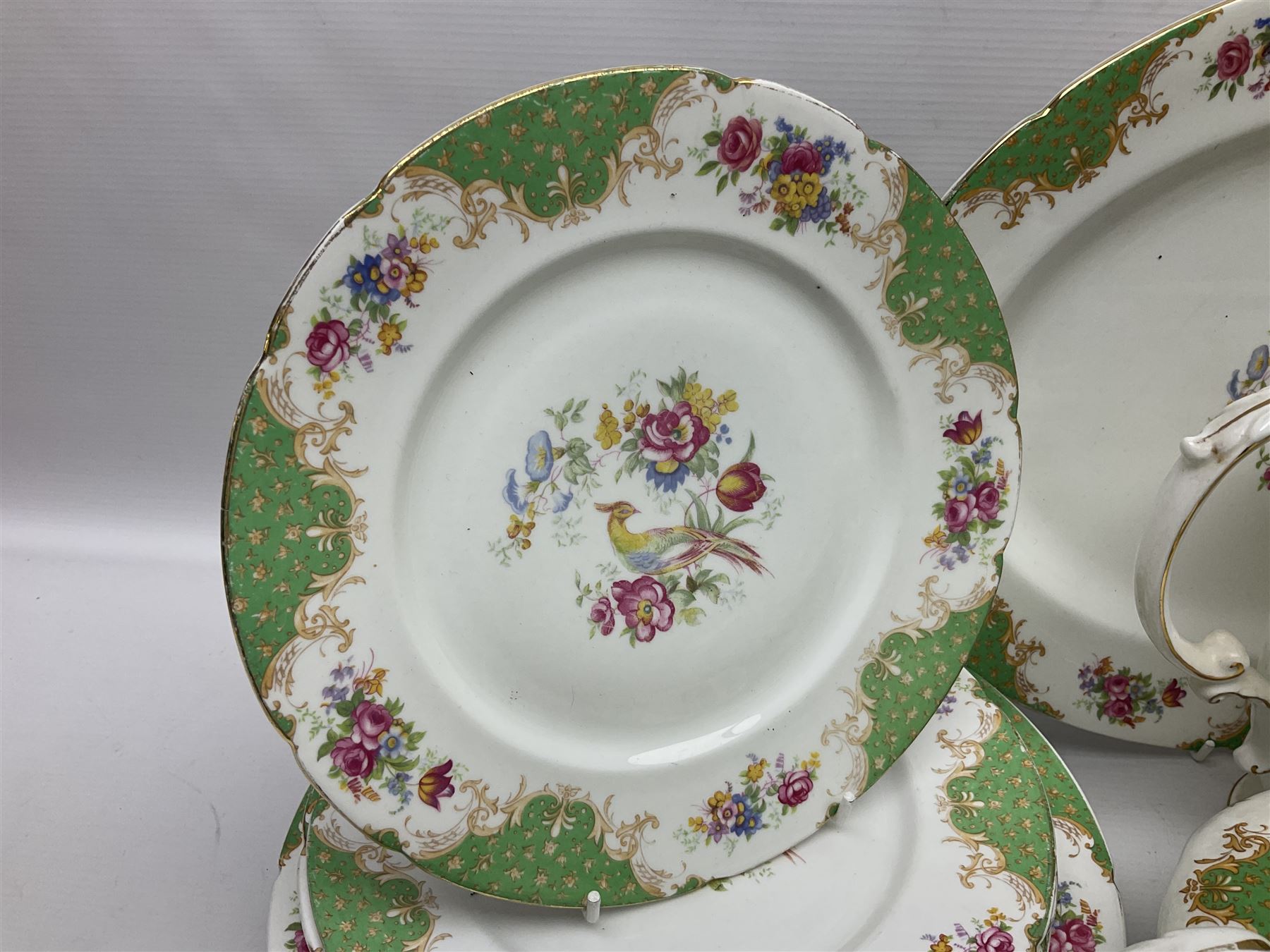 Paragon Rockingham pattern part tea and dinner service including three teapots, milk jug, cups and saucers of various sizes, ten soup bowls, ten side plates, ten dinner plates etc (96)