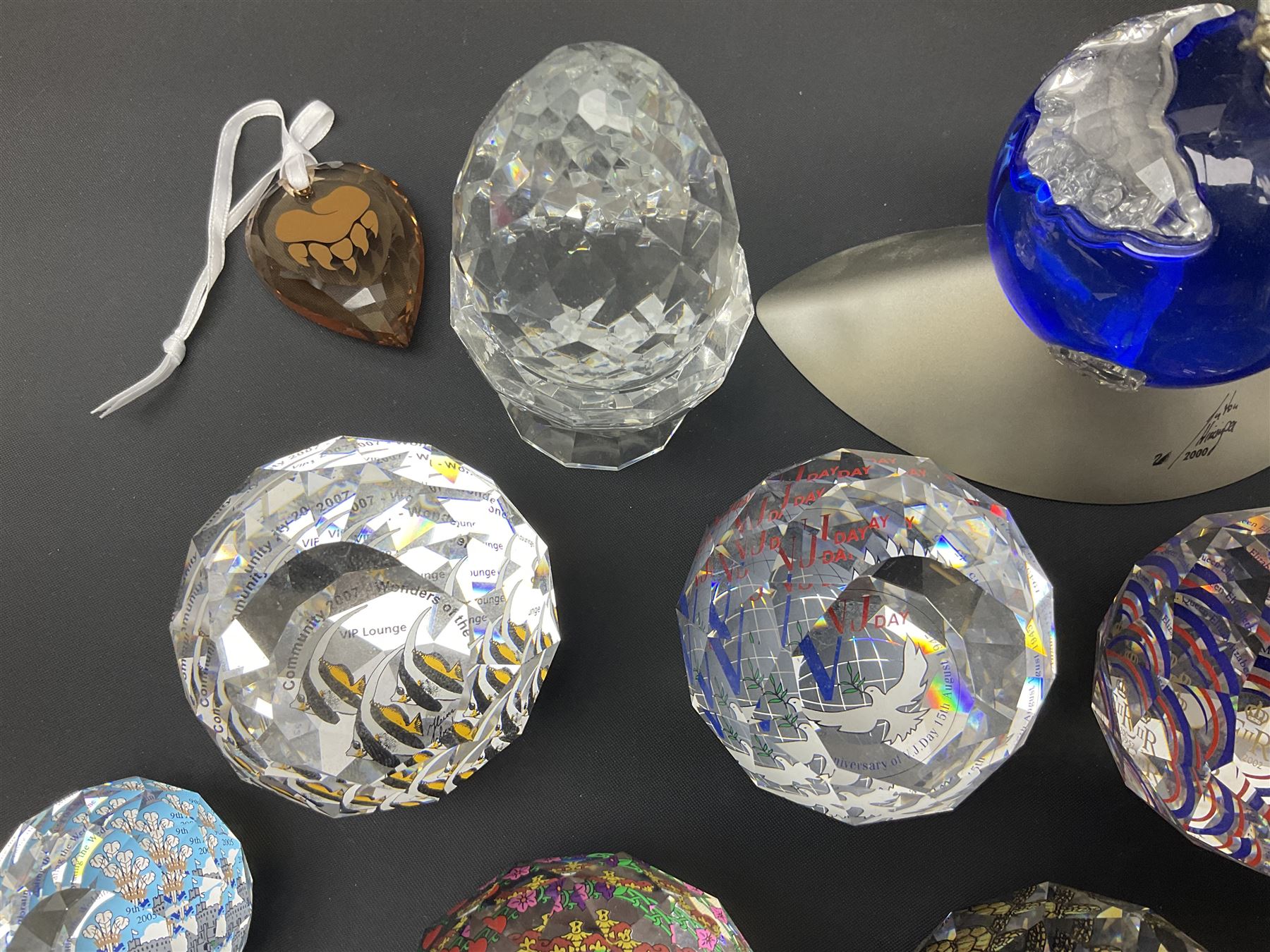 Swarovski Crystal paperweights, to include a globe with dove to the top, pyramid shapes etc, together with a large collection of boxes and stands  