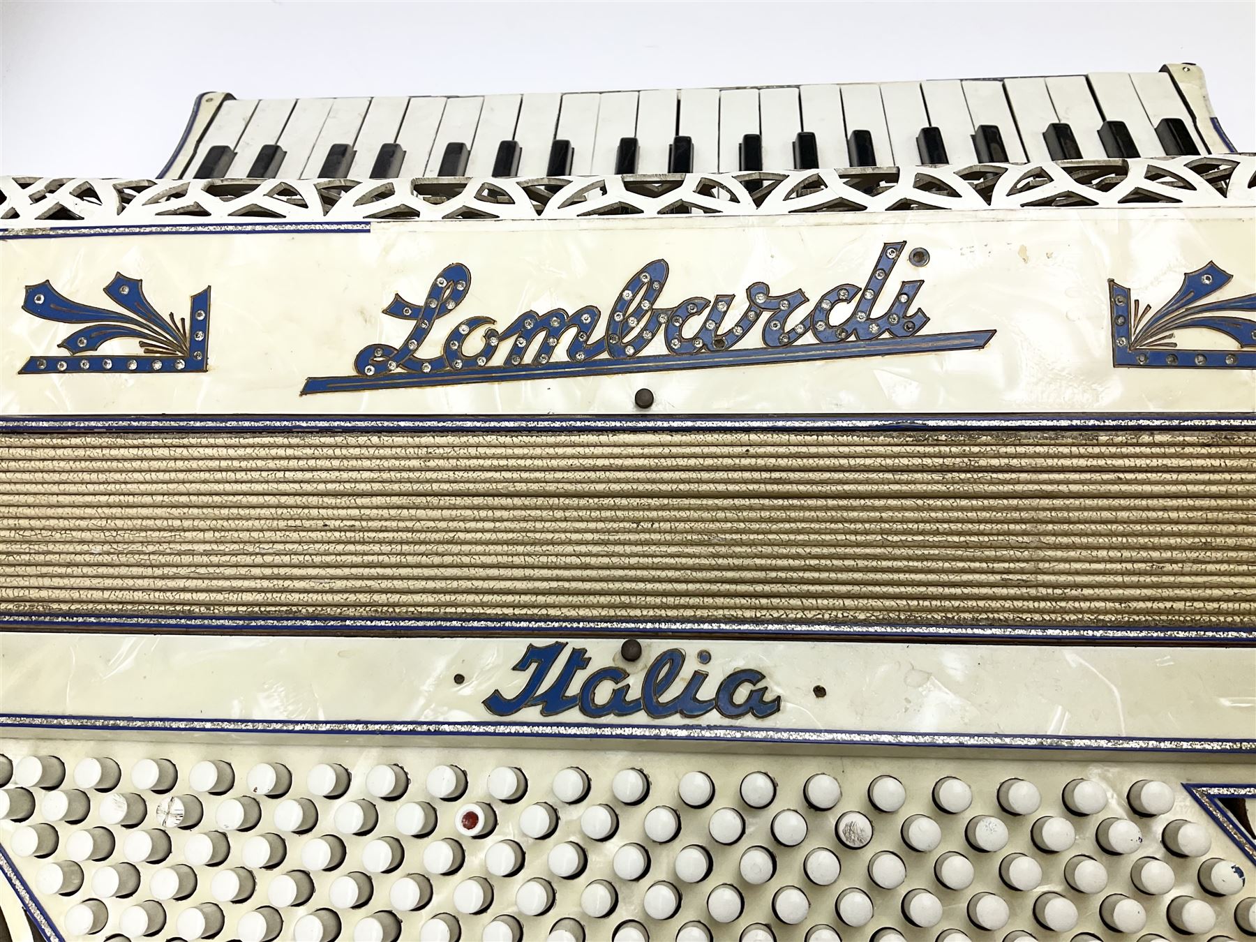 Italian Lambardi piano accordion in ivory coloured pearline case with jewelled decoration, twenty keys and one-hundred and twenty buttons L 37cm