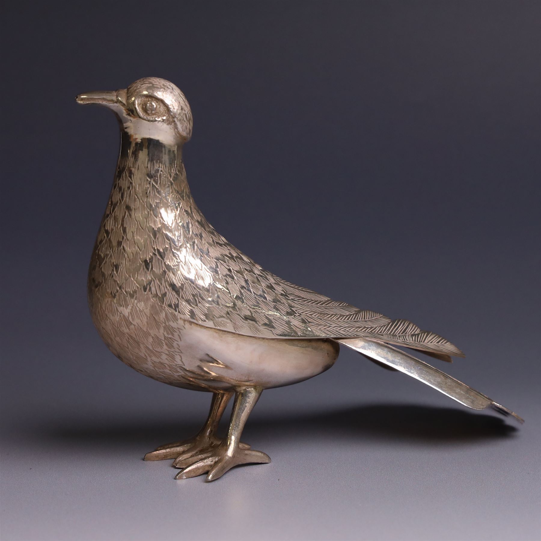 Mid 20th century Iranian silver model of bird, with engraved feathers, stamped with lion with scimitar to underside of tail, H11cm