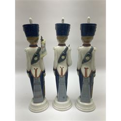 Three Lladro soldier figures, comprising Cadet Captain no 5404, Flag Bearer no 5405 and At Attention no 5407, all with original boxes, H30.5cm  