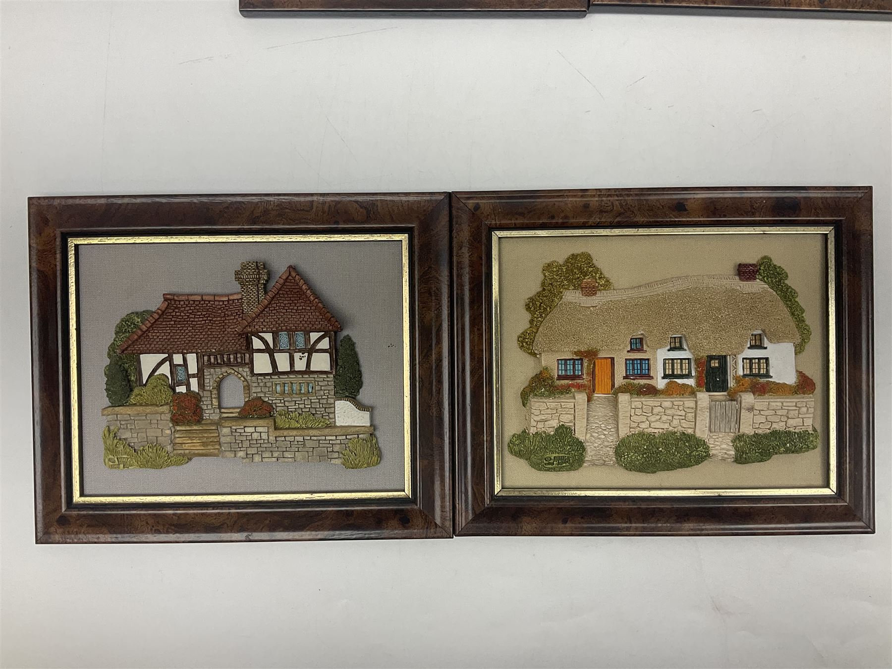 Nine Lilliput Lane framed wall plaques, including Fell View, Battleview, Catslide Cottage, Ashdown Hall and Shannon's Bank, together with three smaller circular framed Lilliput Lane plaques
