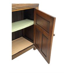 Jacobean design oak court cupboard, upper section with carved arched panelled cupboard door flanked by turned columns, beneath carved and moulded frieze, lower section fitted with two drawers over two cupboard doors with gothic arched panel decoration, raised on stile supports