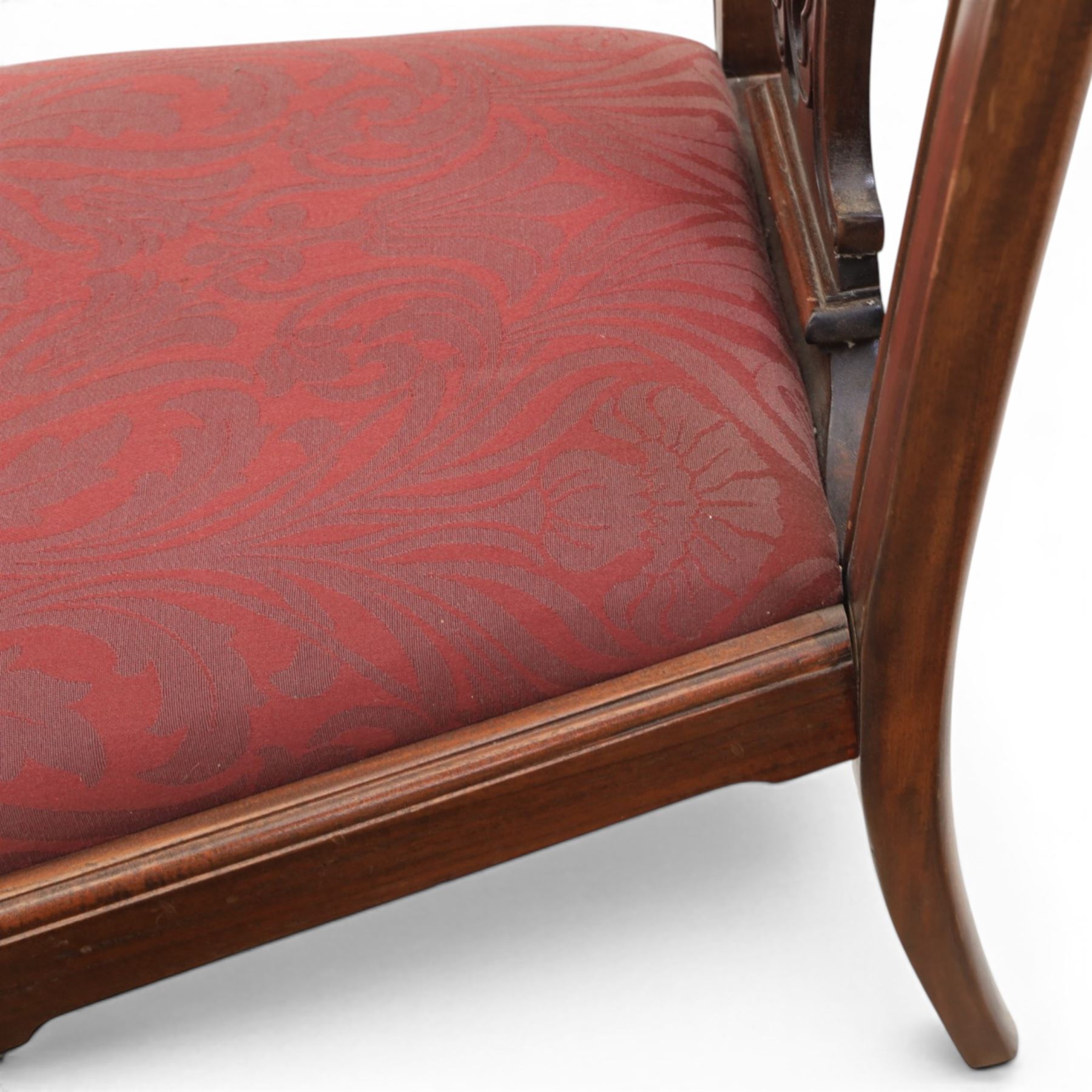 Chippendale design set of ten (8+2) mahogany dining chairs, serpentine cresting rails with carved detail over pierced ribbon-tied splats, red damask upholstered drop-in seats, on cabriole supports with acanthus carved knees and claw and ball feet
