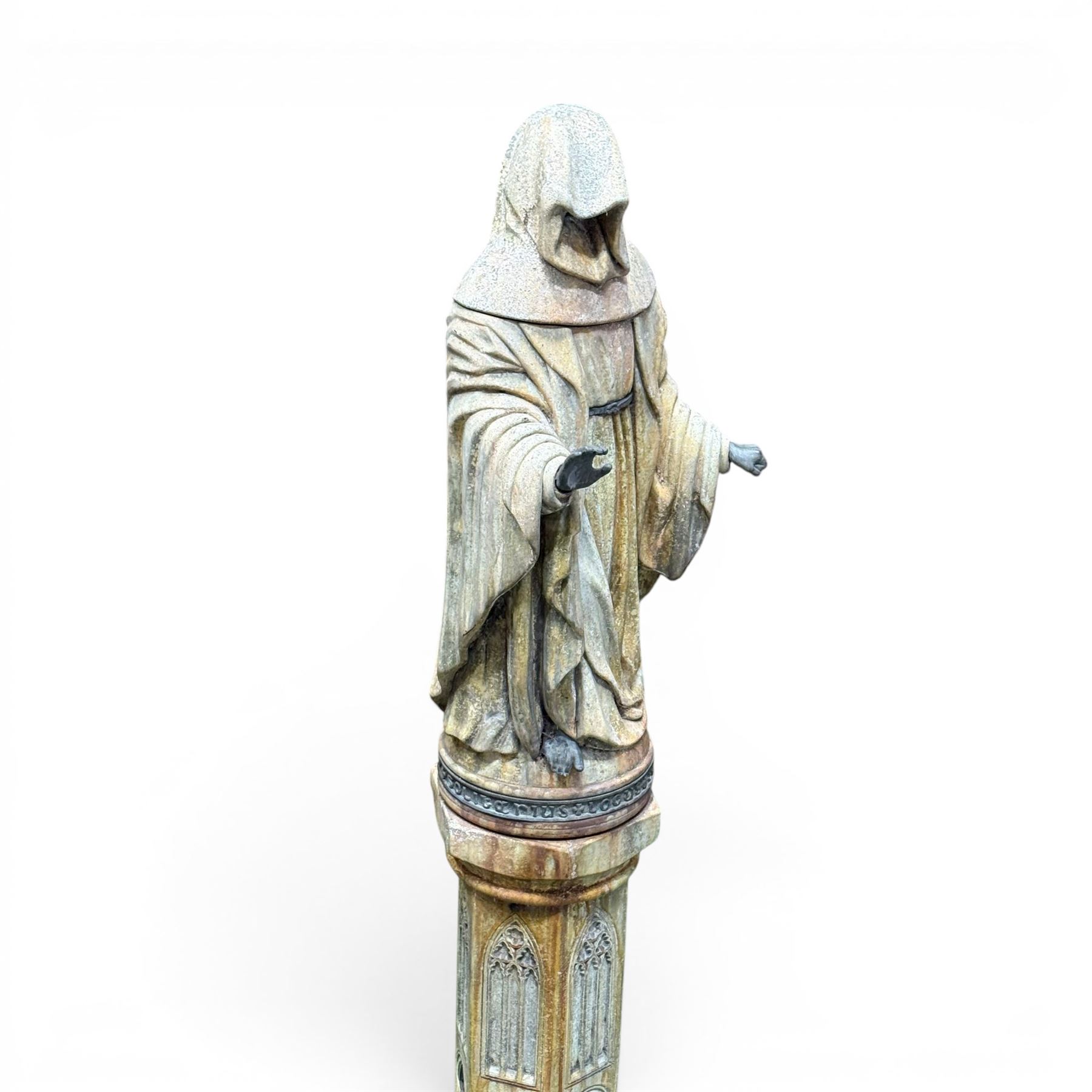 Farran stone garden statue depicting a hooded monk standing in flowing robes in circular form, set upon Gothic pedestal with arched panels, featuring lead hands and script band