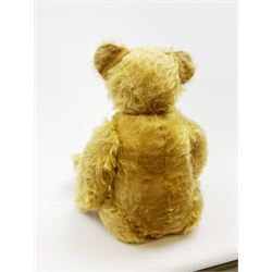 Alpha Farnell Toys large blonde mohair teddy bear with glass eyes, vertically stitched nose and mouth and jointed limbs with stitched claws, label to right foot pad H23.5