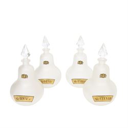 Set of four 20th century Royal Pharmaceutical Society white frosted glass bottles, of bellied form with clear cut glass spire stopper, each body bearing gilt label in Latin: AQ:CINNAM:, AQ:FOENIC:, AQ:HAMAM:, and AQ:ROSACae:, and gilt Royal Pharmaceutical Society crest to neck, H25cm

Provenance: From the collection of the family of Peter Green, a practising pharmacist whose career spanned the mid to late 20th century. During his professional life he managed pharmacies in Yeovil, Somerset, and later Selles Chemist in Filey, North Yorkshire, before purchasing and running his own business, Peter Green Pharmacy, located in the Market Place, Malton. The bottles were displayed as part of the traditional shop fittings in both the Filey and Malton pharmacies and were retained as part of his collection.