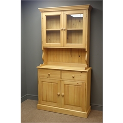  Solid pine dresser, projecting cornice, two glazed cupboards doors enclosing two shelf, above two drawers and two cupboard doors, plinth base, W101cm, H195cm, D35cm  