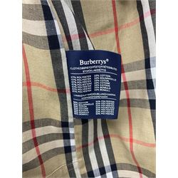 Ladies Burberry double breasted trench coat, with belt and detachable woollen gilet, in traditional cream colour with Burberry check lining, together with a gentlemans Burberry single breasted trench coat, both L112cm
