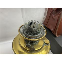 Brass oil lamp, with etched floral glass shade, leather Gladstone style doctors bag, leather satchel and vintage vanity case, three graduating wooden giraffes and other wood and metal ware, lamp H54cm