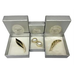 Christian Dior costume jewellery, comprising pair of pearlescent clip on earrings, enamel and paste leaf brooch and a pierced stylised leaf brooch, each stamped Chr.Dior Germany and in original boxes