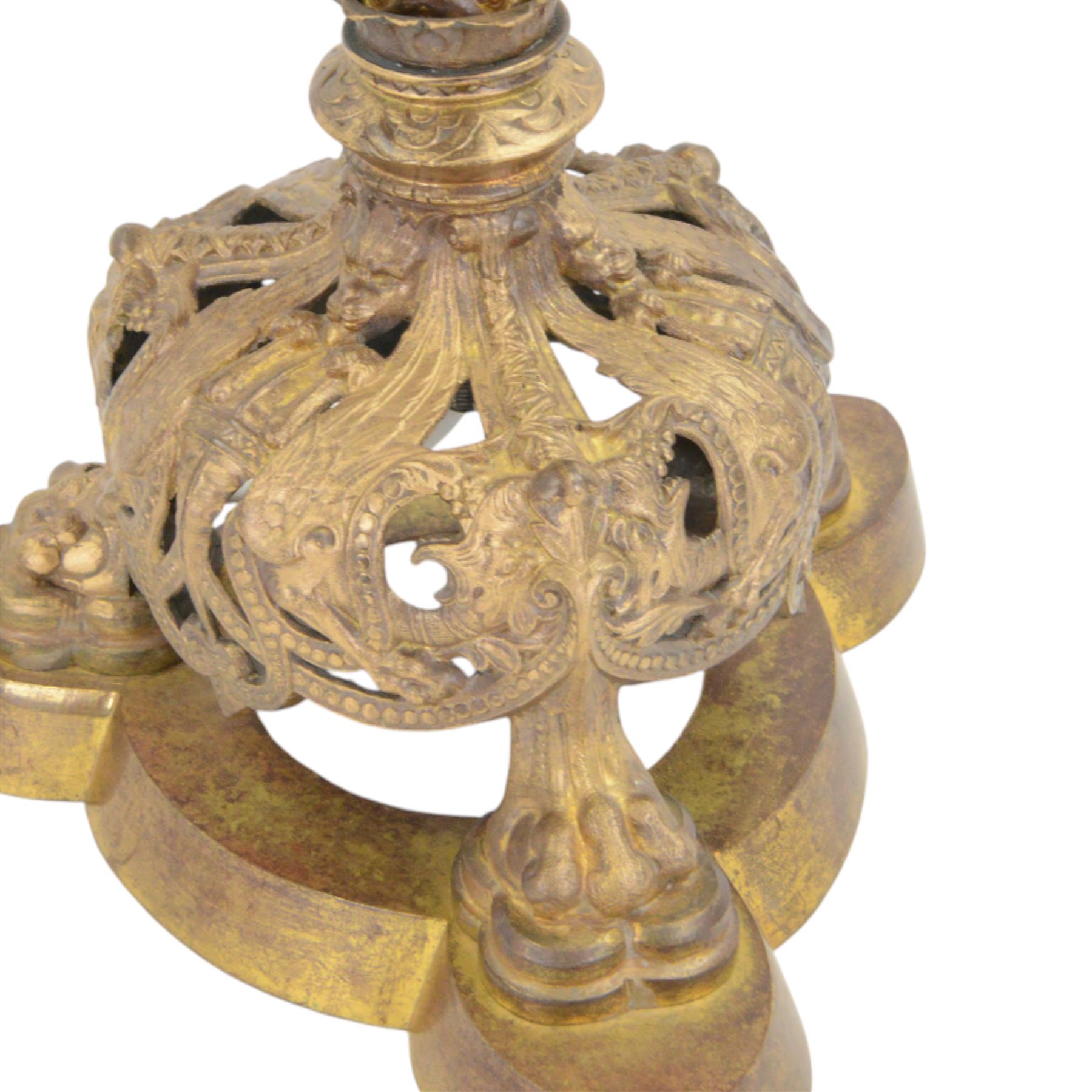 Gilt table lamp, three lion paw feet on a triangular base with column central support decorated with floral motifs, with octagonal shade, H85cm 