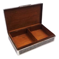 Indian silver cigarette box, of rectangular form with chassed and embossed foliate decoration and vacant rectangular panel to hinged cover, opening to reveal softwood lined interior with division, H3.3cm W14.3cm D8.5cm, stamped Silver VR Co with elephant mark