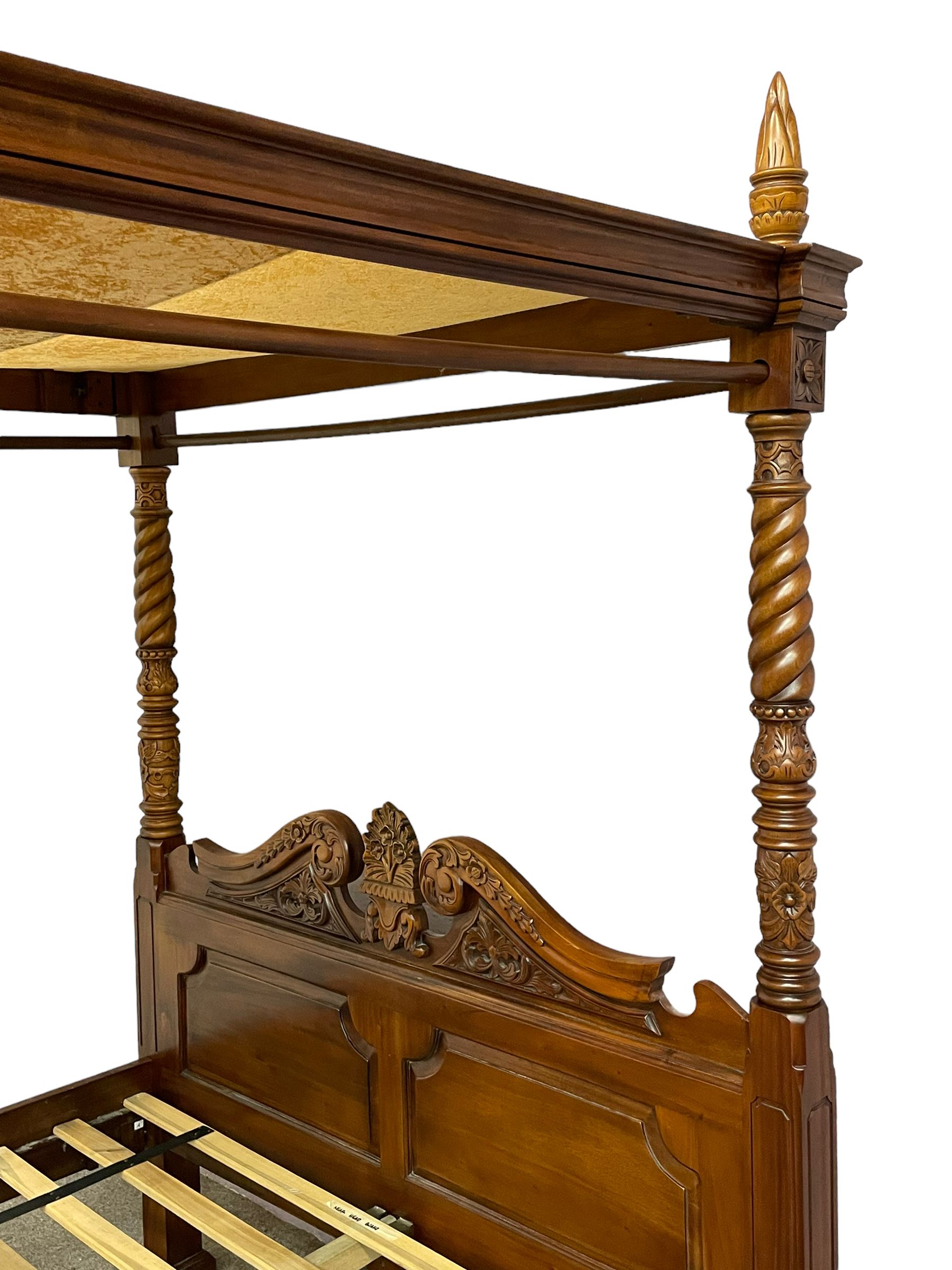 Georgian design mahogany 5' King-size four-poster bed, projecting moulded canopy top on twist-turned columns carved with acanthus leaves and flower heads, the headboard with scrolled broken swan neck pediment carved with scrolled foliage and with central anthemion, on flower head carved ball and claw front feet, with torch and foliate carved pointed finials