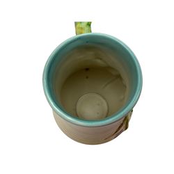 Clarice Cliff baluster jug moulded with a blue budgerigar perched upon branch with green rustic handle and mushroom glaze,  factory stamped beneath, H22.5cm