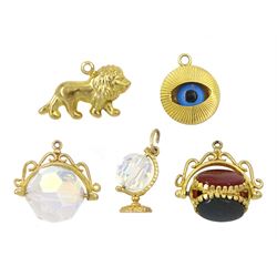 Five 9ct gold pendant/charms including onyx, carnelian and bloodstone swivel, Evil Eye, crystal globe and swivel and a lion