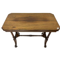Late Victorian rosewood stretcher table, the rectangular top with curved canted cornice and moulded edge, on quadruple turned pillar supports carved with foliage, joined by collar turned stretcher, on splayed moulded supports with brass and ceramic castors