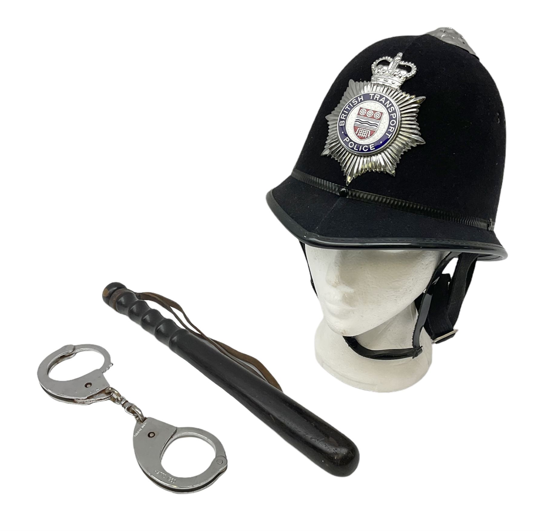 British Transport Police Custodian helmet with Queen's Crown plate; Hiatt & Co ebonised hardwood patrol truncheon; and pair of Hiatts 1960 hand-cuffs (3)