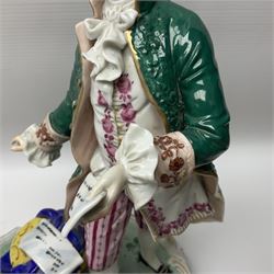 20th century Naples figure group, modelled as a seated female figure playing the lute seated, before a male figure stood holding a sheet of music, each in period dress, upon an oval base with gilt heightened scroll edge, with crowned N mark beneath, H31.5cm L33cm
