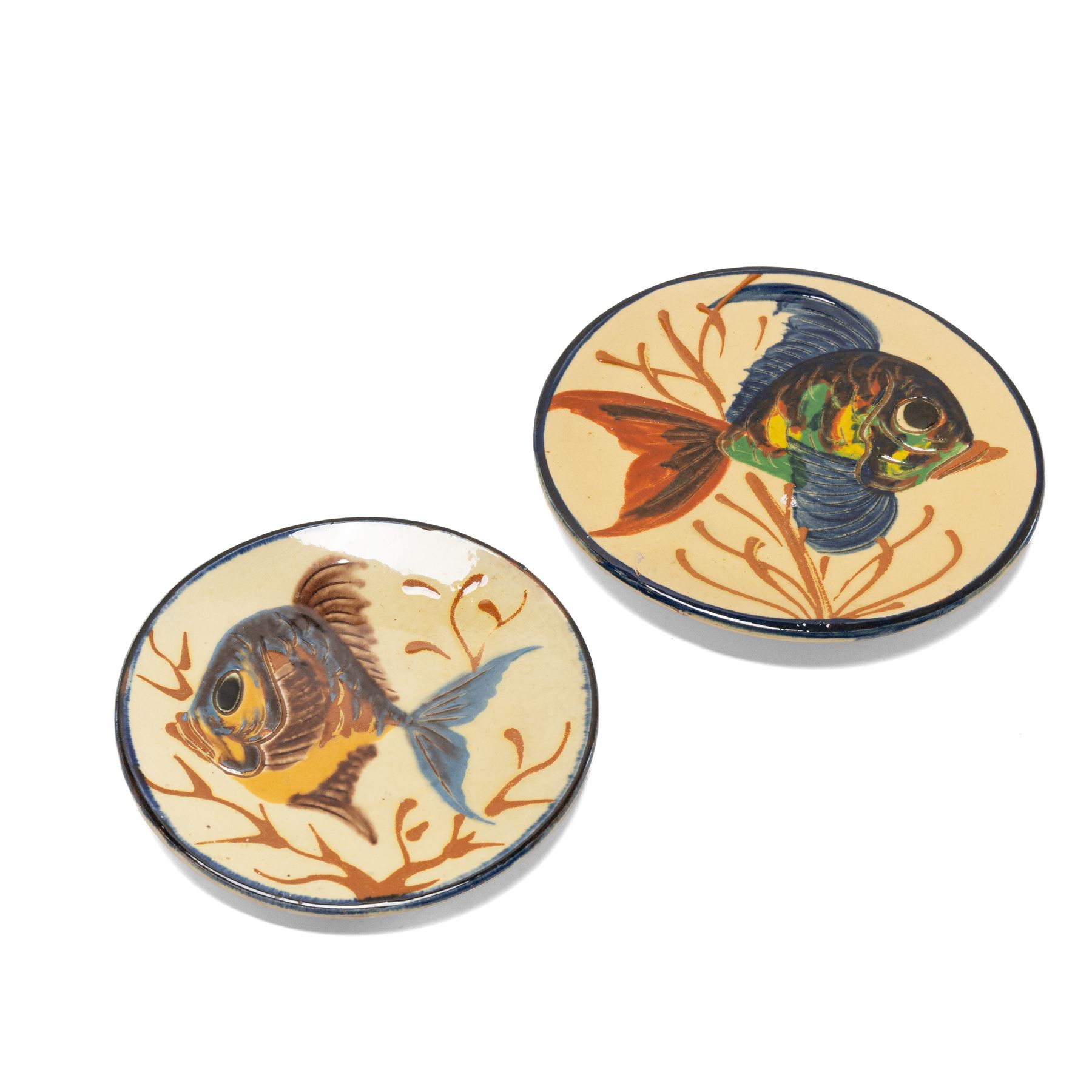 Puigdemont studio pottery slipware chargers, each uniquely decorated with stylised fish, largest D28cm 