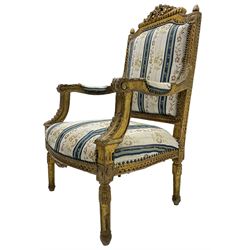  Late 20th century French design carved giltwood armchair, the cresting rail carved with scrolled foliage over foliate carved platform, upholstered in striped fabric decorated with trailing foliage and flower heads, acanthus carved arm terminals and upright supports, on turned and fluted supports 