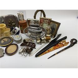 A group of assorted collectables, to include small oval purple guilloche enamel frame, WWII matchbox holder depicting Winston Churchill, Halcyon Days enamel box, Ronson table lighter, ebonised glove stretchers, ivory napkin ring, mother of pearl handled button hook, engine turned cigarette case, etc. 