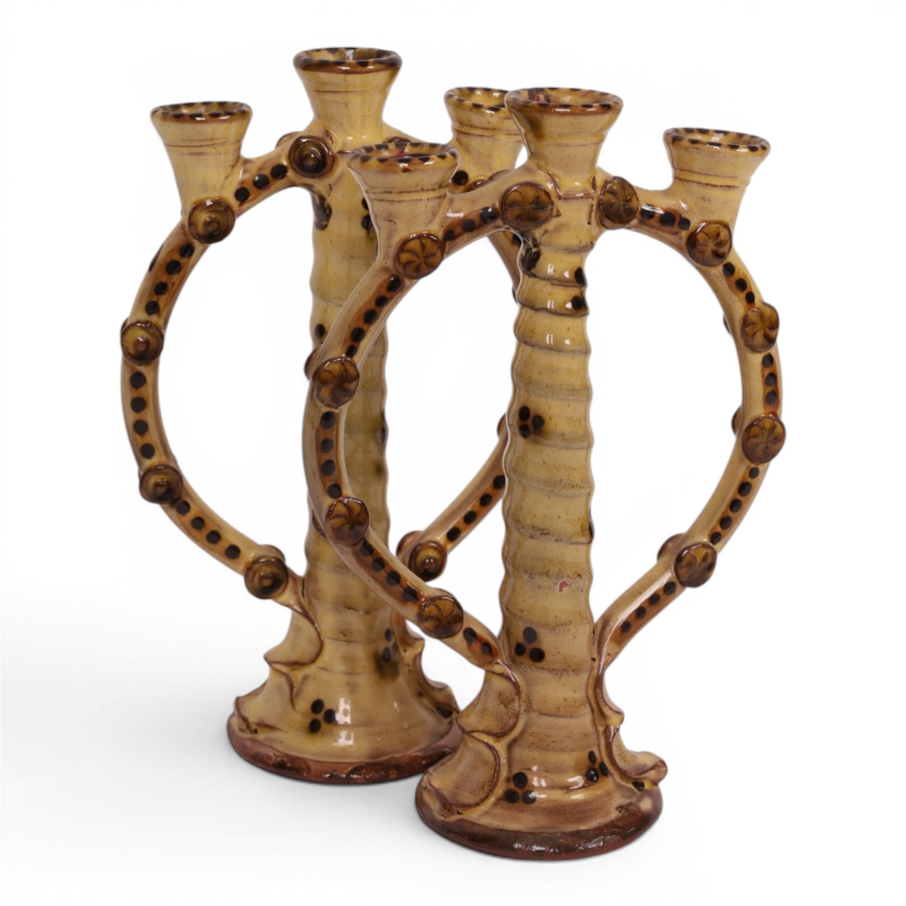 Pair of studio pottery candlesticks, with a central twisted column bordered by circular supports, H24cm 